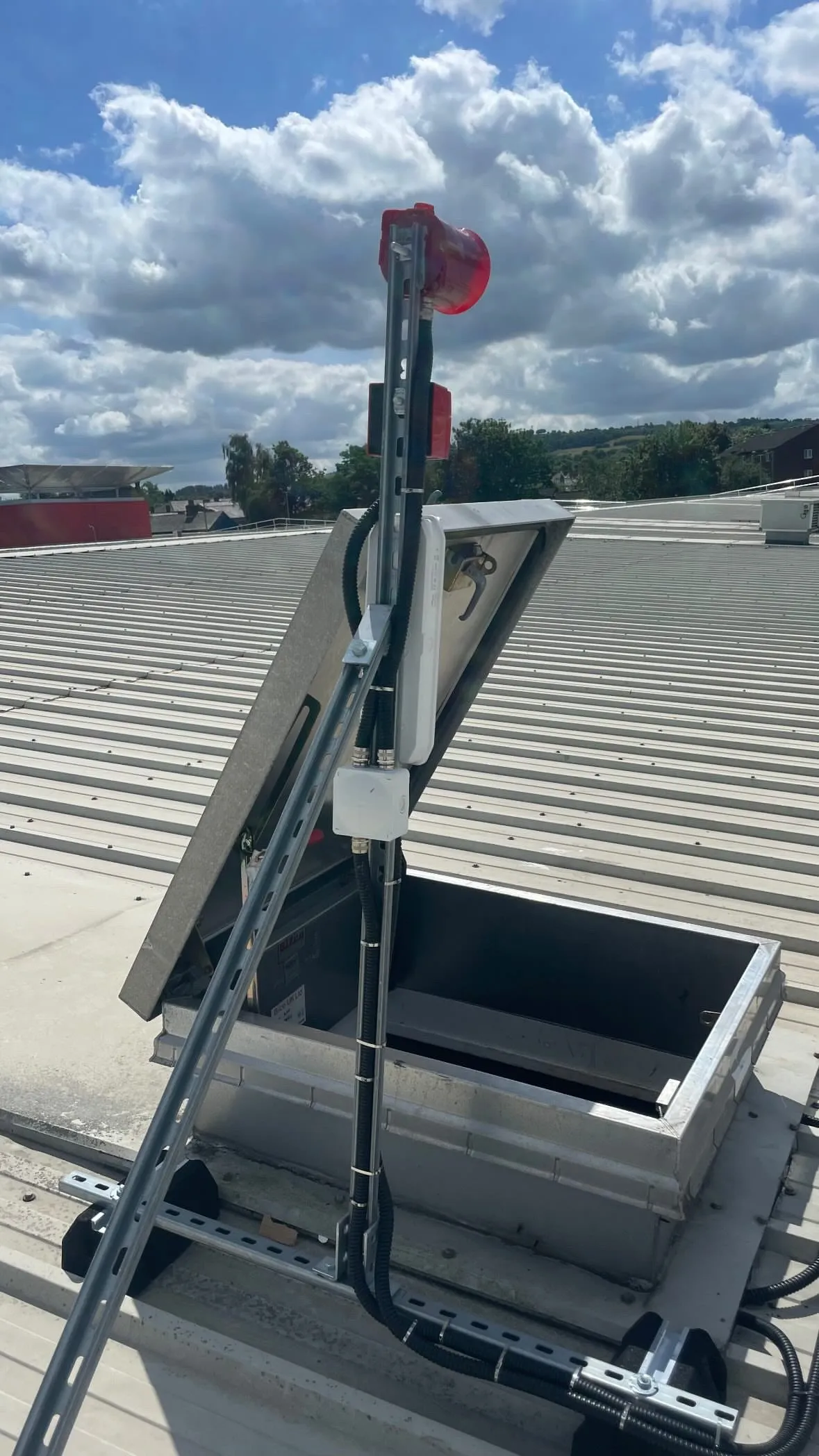 Fire alarm beacon and control equipment serving the roof access point.