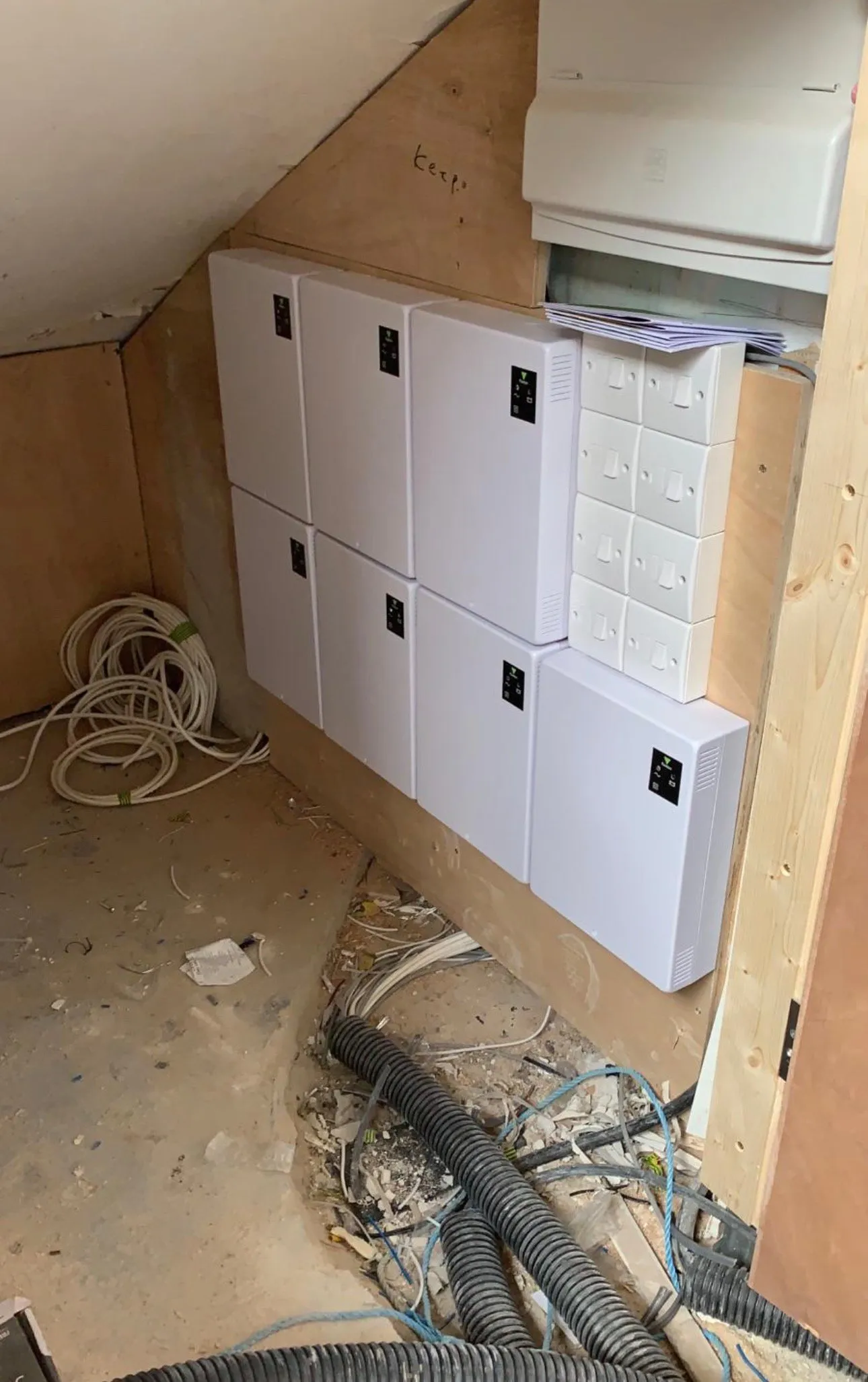Completed bank of access control enclosures with tidy first-fix cabling below.