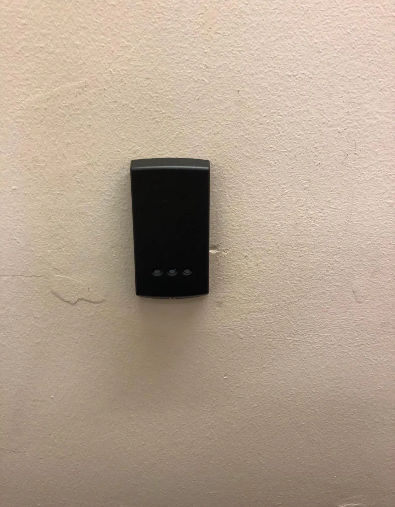 Discreet proximity card reader mounted for secure internal door access.